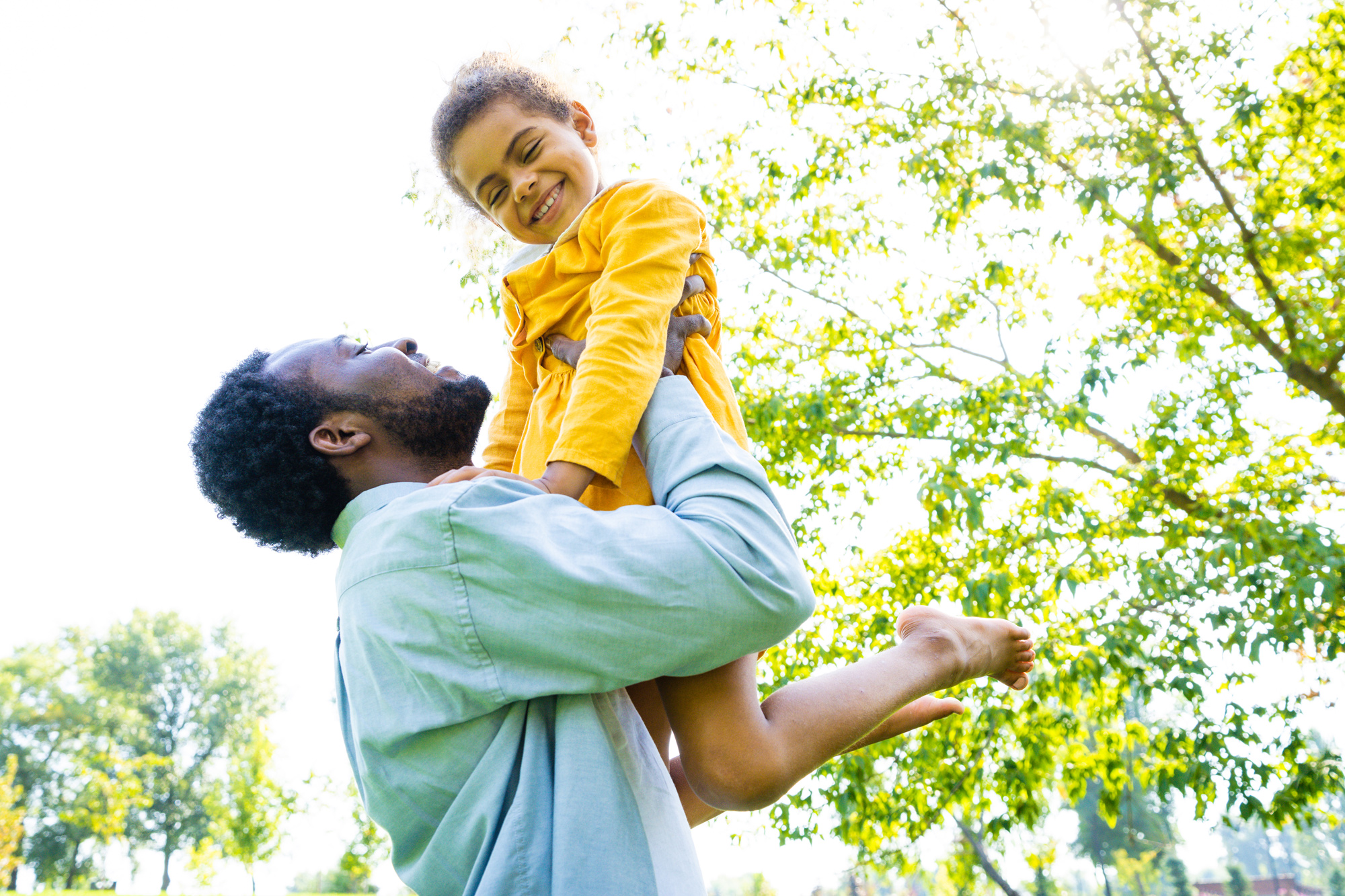 web_happy-child-lifted-up-by-adult-in-park-2026-09-22-06-42-39-utc
